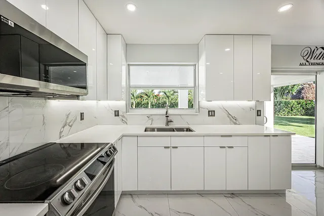 a kitchen with a sink and a stove top oven