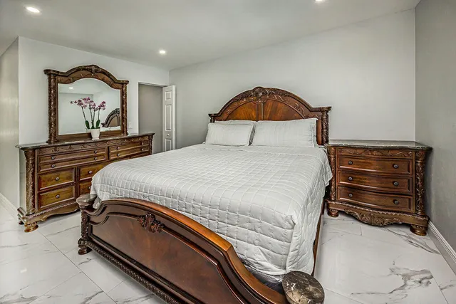 a bedroom with a bed and dresser