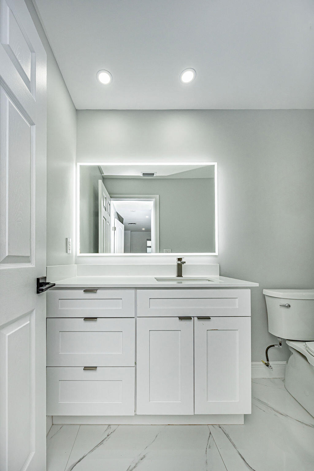 1881 Caribbean Road West Lake Clarke Shores, FL 33406 - Photo 22 of 40 a bathroom with a sink and a mirror