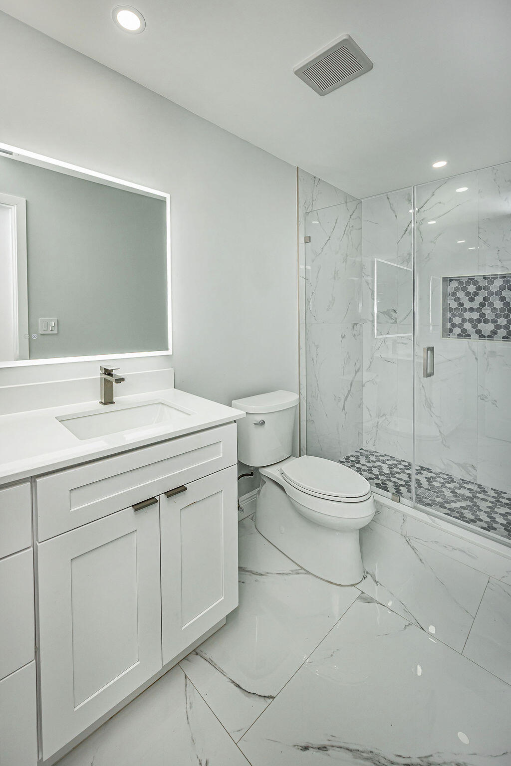 1881 Caribbean Road West Lake Clarke Shores, FL 33406 - Photo 23 of 40 a bathroom with a sink a toilet and shower