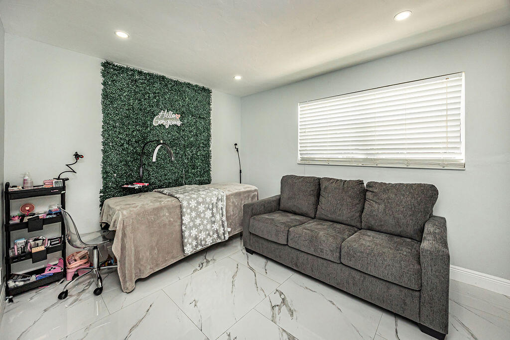 1881 Caribbean Road West Lake Clarke Shores, FL 33406 - Photo 24 of 40 a living room with furniture and a window