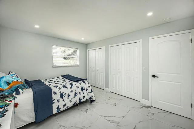 a bedroom with a bed and a window