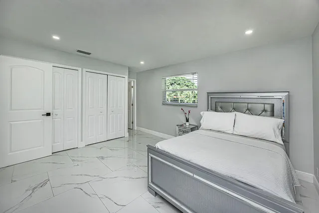 a room with a bed and a chandelier