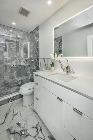 a bathroom with a sink toilet and shower