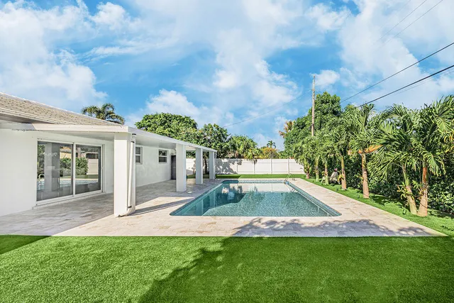 a view of a house with a swimming pool and garden