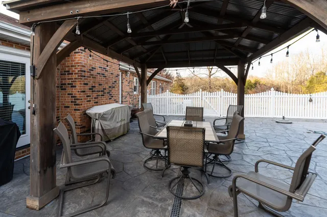a view of a dining room with furniture and chandelier
