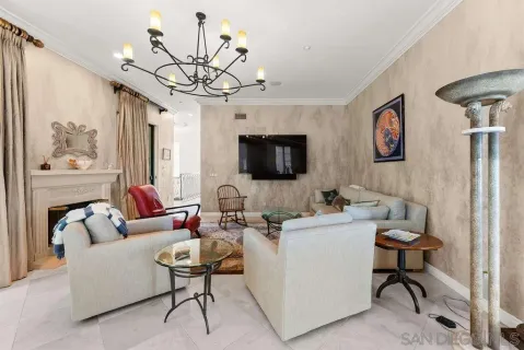 a living room with furniture a flat screen tv and a window