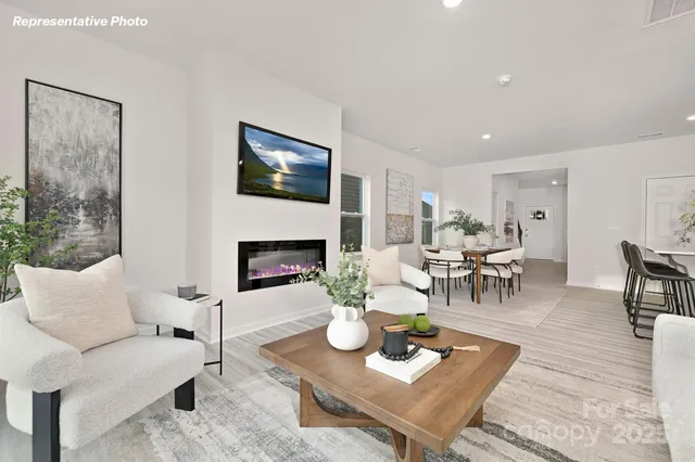 a living room with furniture a table and a fireplace
