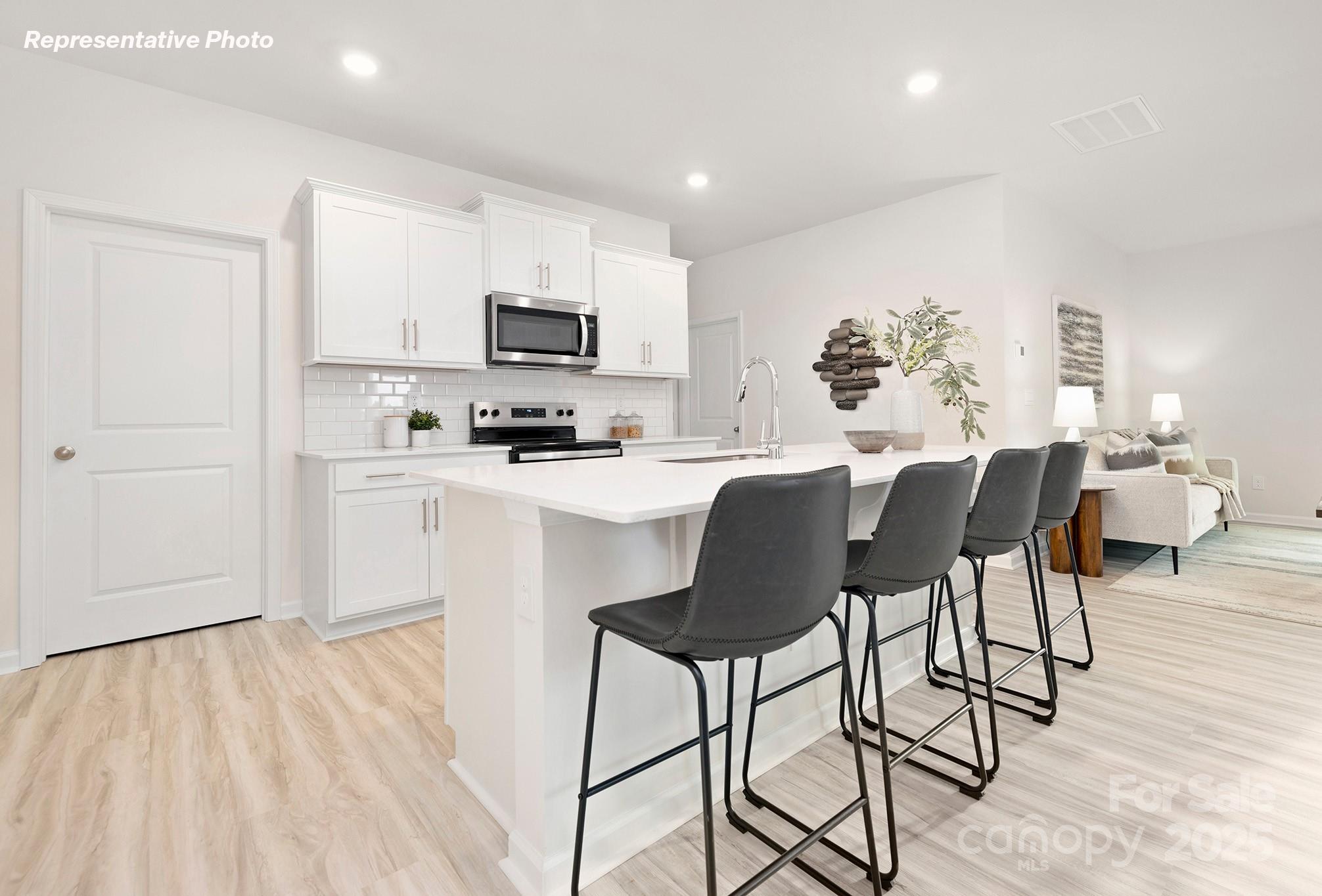 2693 Goose Fair Road Maiden, NC 28650 - Photo 5 of 29 a kitchen with stainless steel appliances a dining table chairs refrigerator and sink