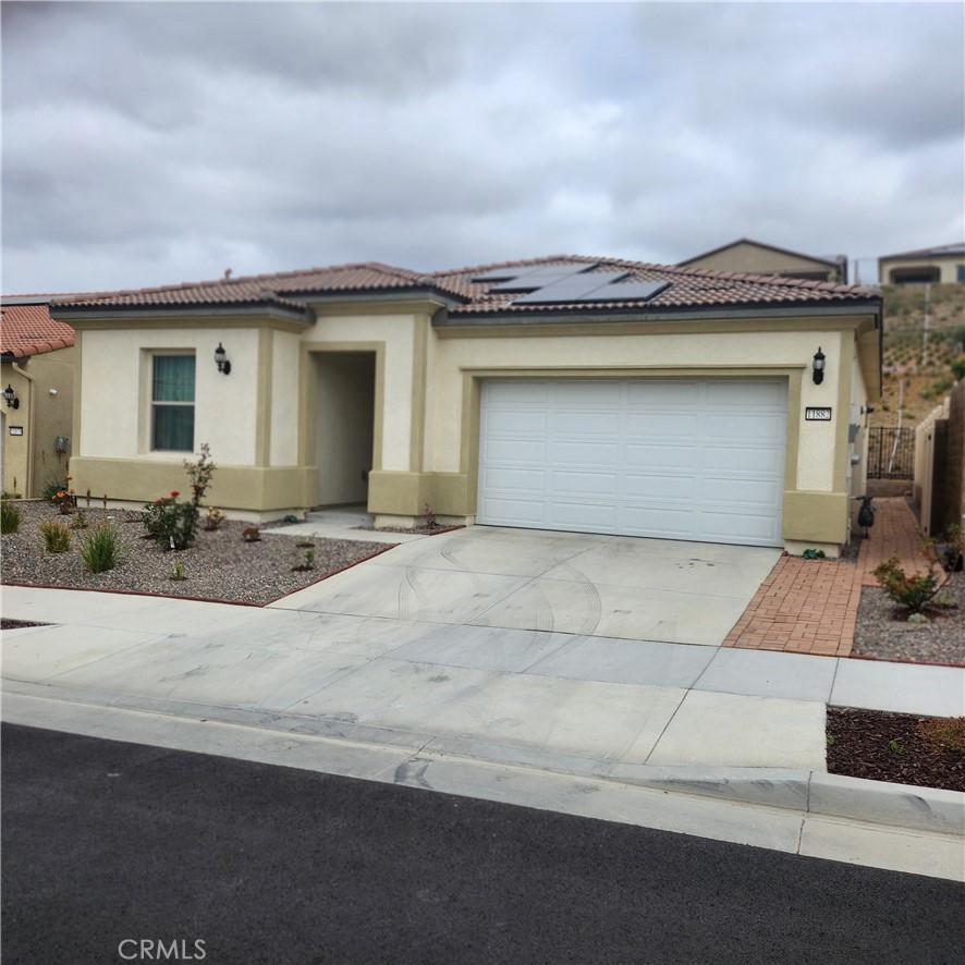11882 Wandering Way Corona, CA 92883 - Photo 1 of 38 a front view of a house with a yard and garage
