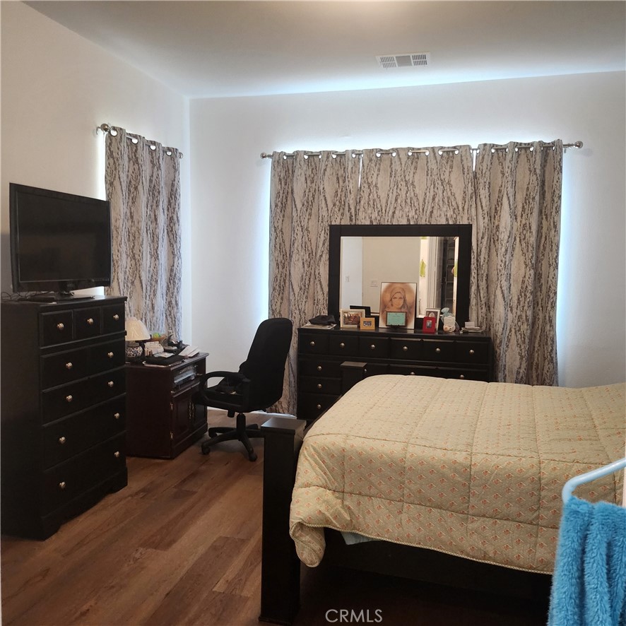 11882 Wandering Way Corona, CA 92883 - Photo 11 of 38 a living room with a couch and a flat screen tv