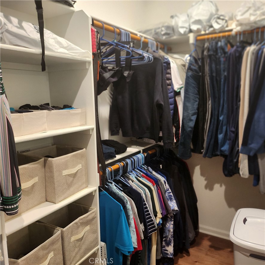 11882 Wandering Way Corona, CA 92883 - Photo 19 of 38 a view of walk in closet with clothes and shoes