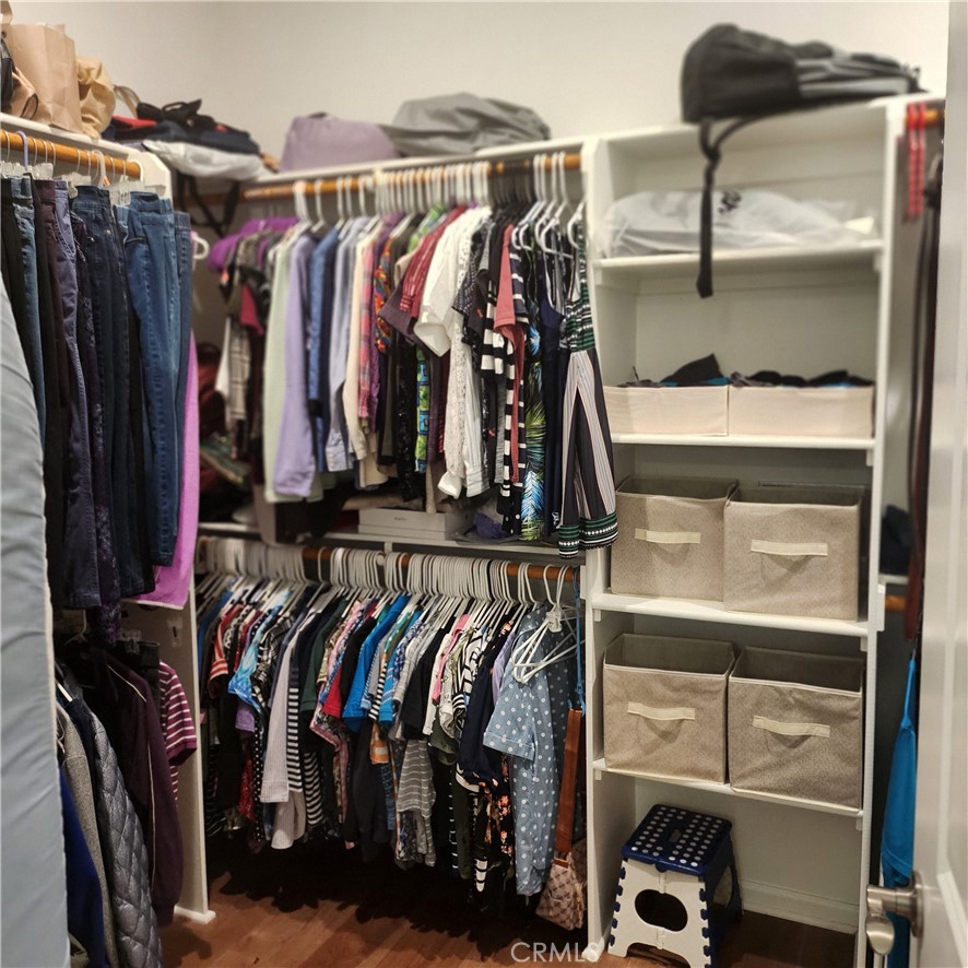 11882 Wandering Way Corona, CA 92883 - Photo 20 of 38 a view of walk in closet with clothes and shoes