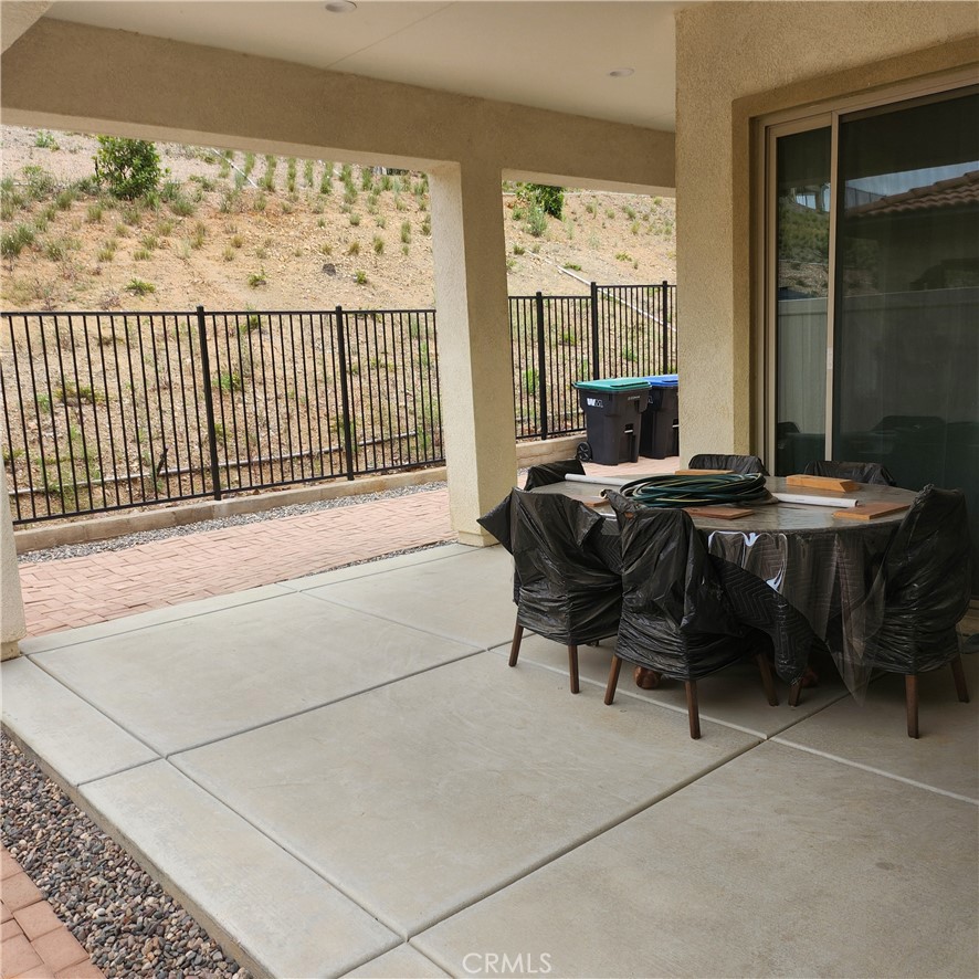 11882 Wandering Way Corona, CA 92883 - Photo 25 of 38 a living room with furniture a table and a large window