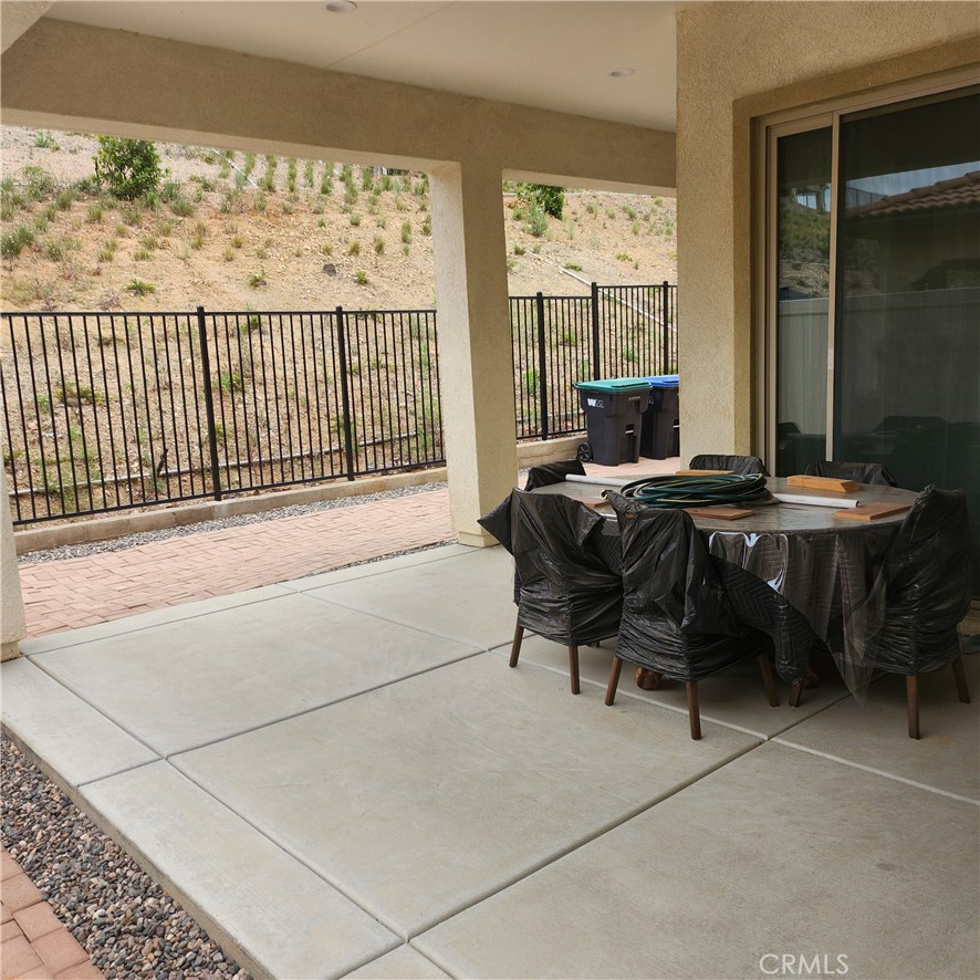 11882 Wandering Way Corona, CA 92883 - Photo 28 of 38 a living room with furniture a table and a large window