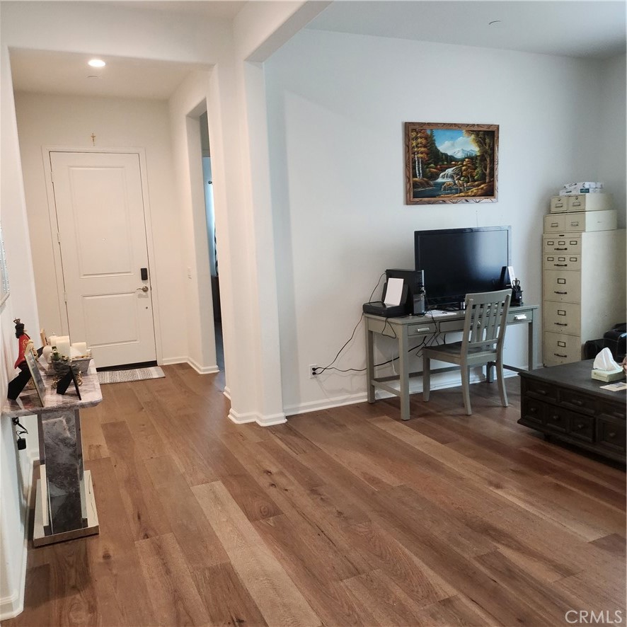 11882 Wandering Way Corona, CA 92883 - Photo 9 of 38 a workspace with furniture and a wooden floor