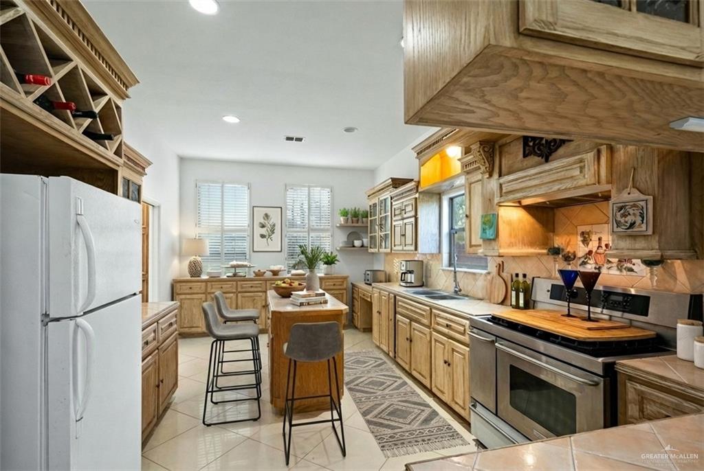912 North Bentsen Road McAllen, TX 78501 - Photo 13 of 45 a kitchen with stainless steel appliances granite countertop a sink a stove and a refrigerator