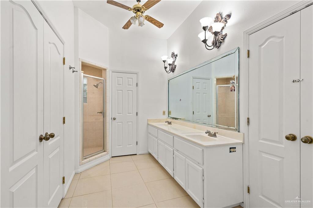 912 North Bentsen Road McAllen, TX 78501 - Photo 28 of 45 a bathroom with a double vanity sink a mirror and a bathtub
