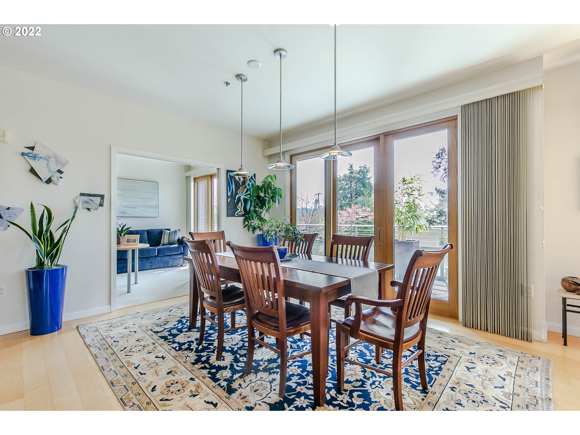 1375 Olive Street, Unit 201 Eugene, OR 97401 - Photo 12 of 32 a view of a dining room and livingroom with furniture wooden floor a chandelier