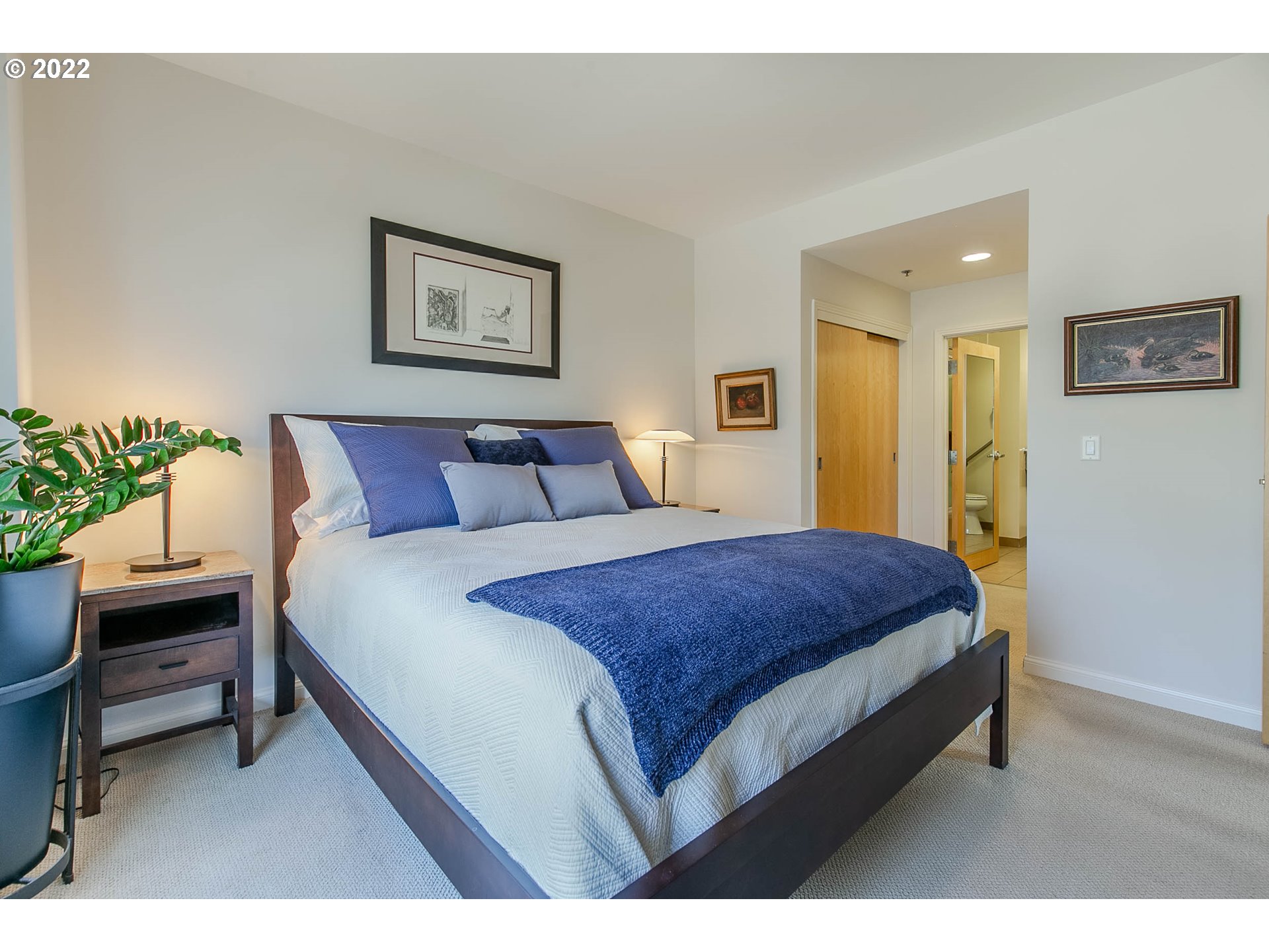 1375 Olive Street, Unit 201 Eugene, OR 97401 - Photo 22 of 32 a bedroom with a bed and a chair