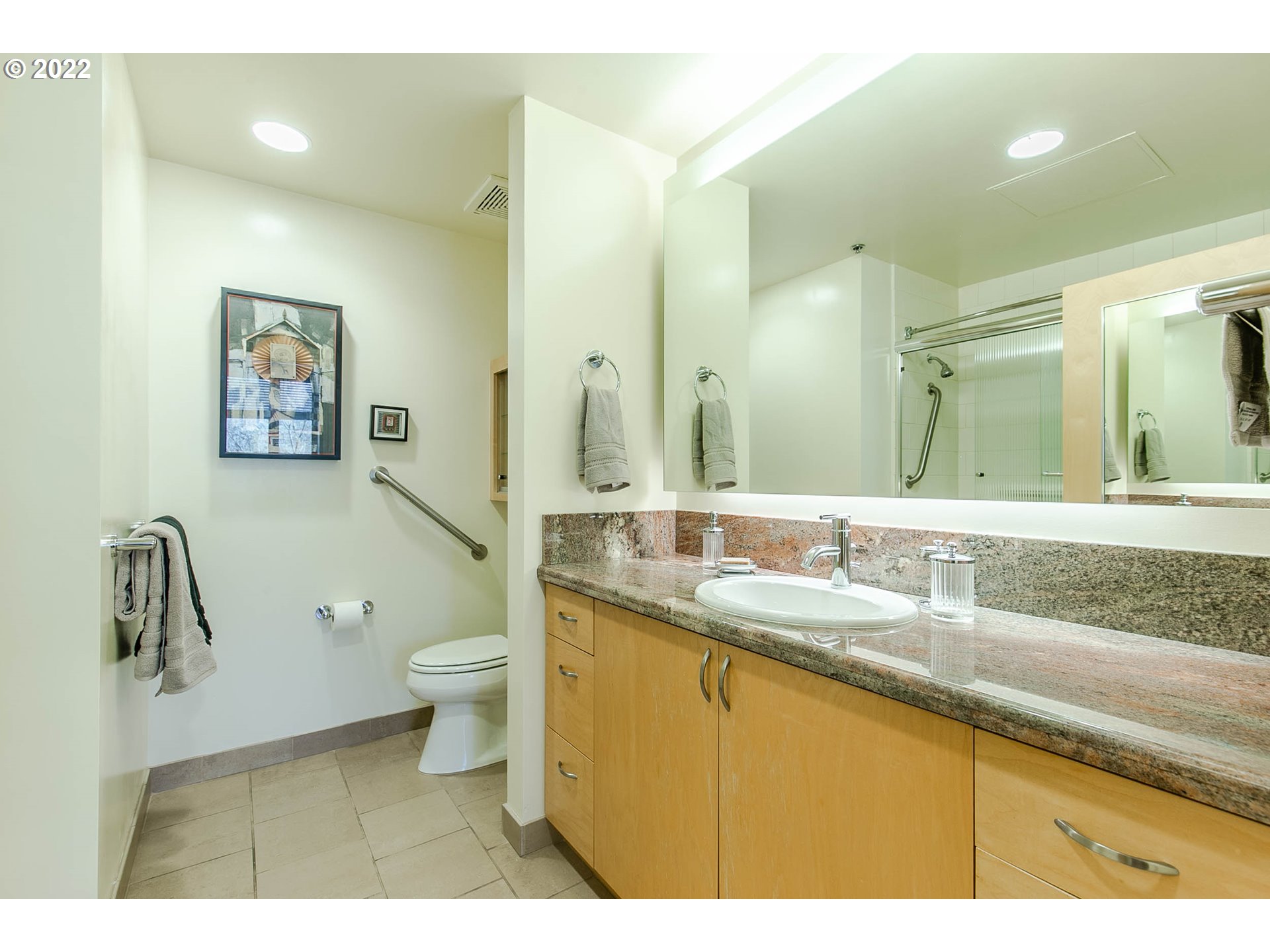1375 Olive Street, Unit 201 Eugene, OR 97401 - Photo 25 of 32 a bathroom with a granite countertop sink a toilet and a mirror