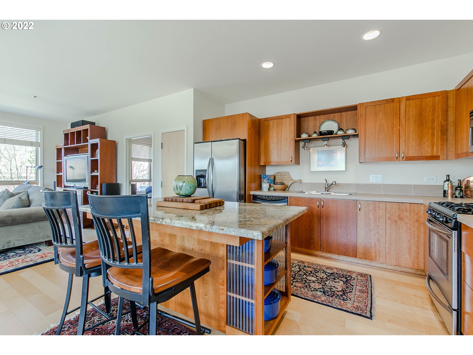 1375 Olive Street, Unit 201 Eugene, OR 97401 - Photo 7 of 32 a kitchen with stainless steel appliances granite countertop a table chairs sink and cabinets