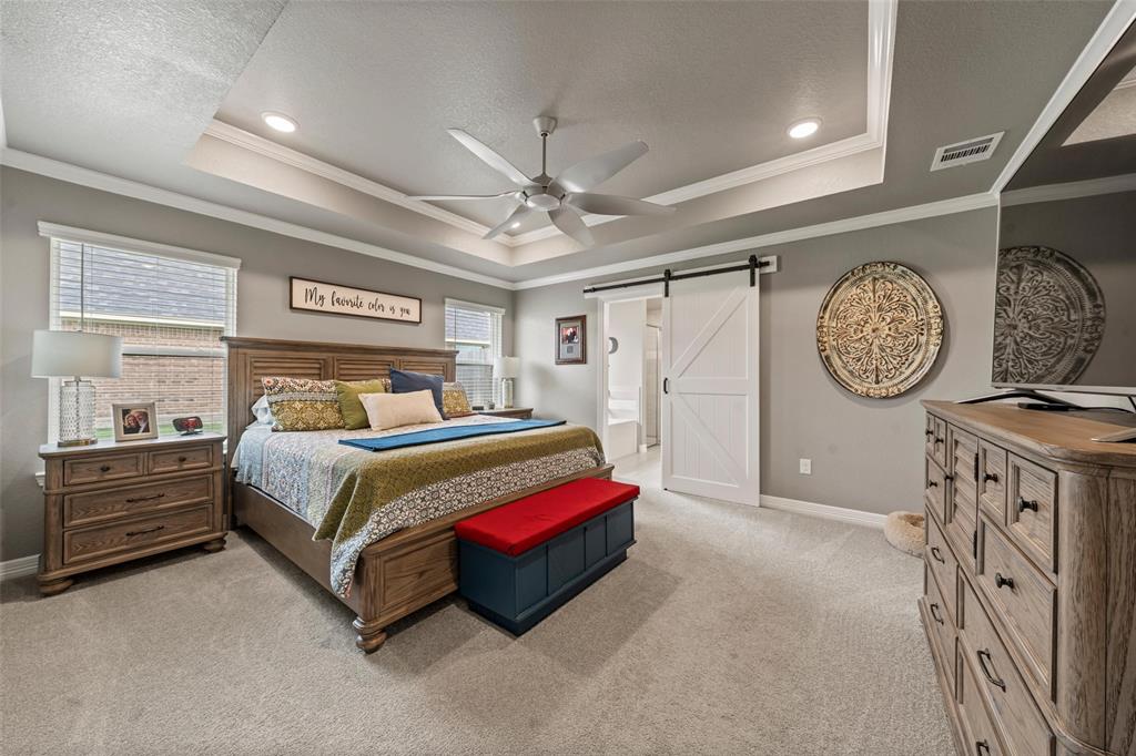 828 Agile Street Hewitt, TX 76643 - Photo 22 of 30 a bedroom with a bed and a large mirror on the dresser