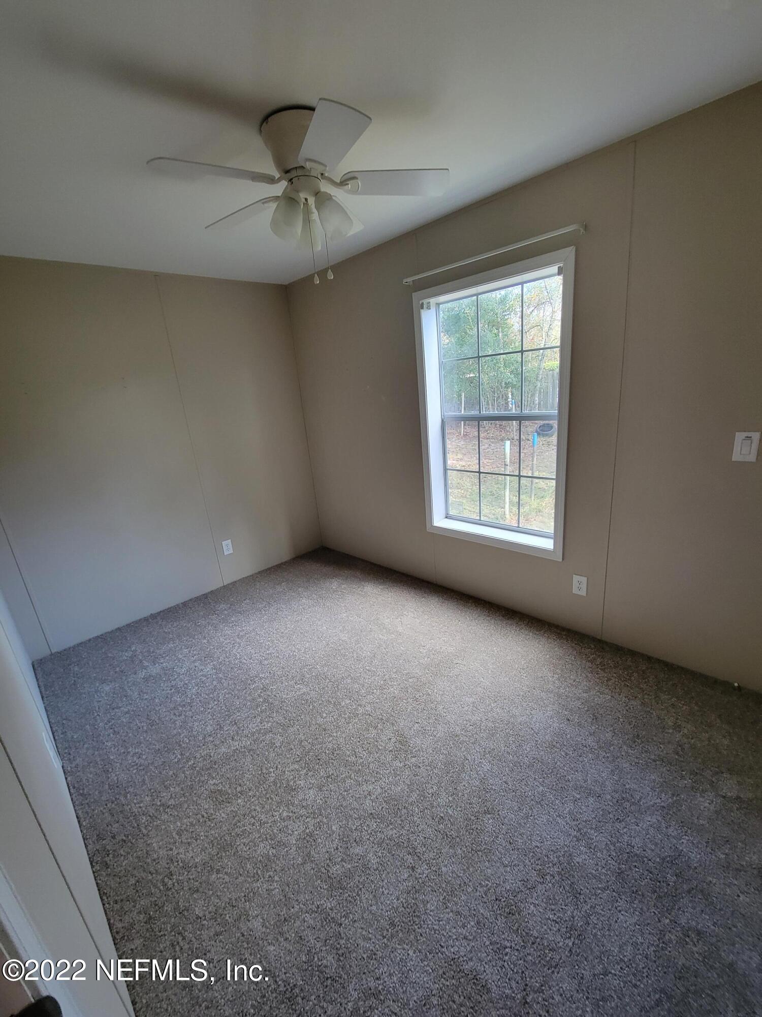 7157 Gas Line Road Keystone Heights, FL 32656 - Photo 11 of 11 an empty room with a ceiling fan and window