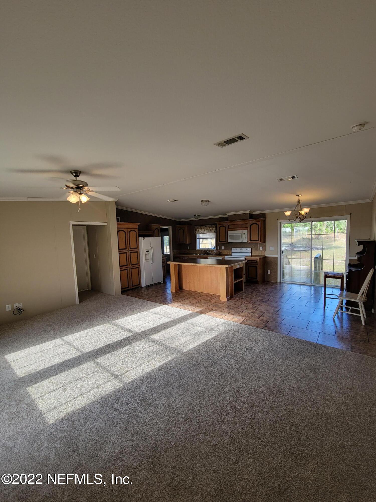 7157 Gas Line Road Keystone Heights, FL 32656 - Photo 10 of 11 a living room with furniture and a table