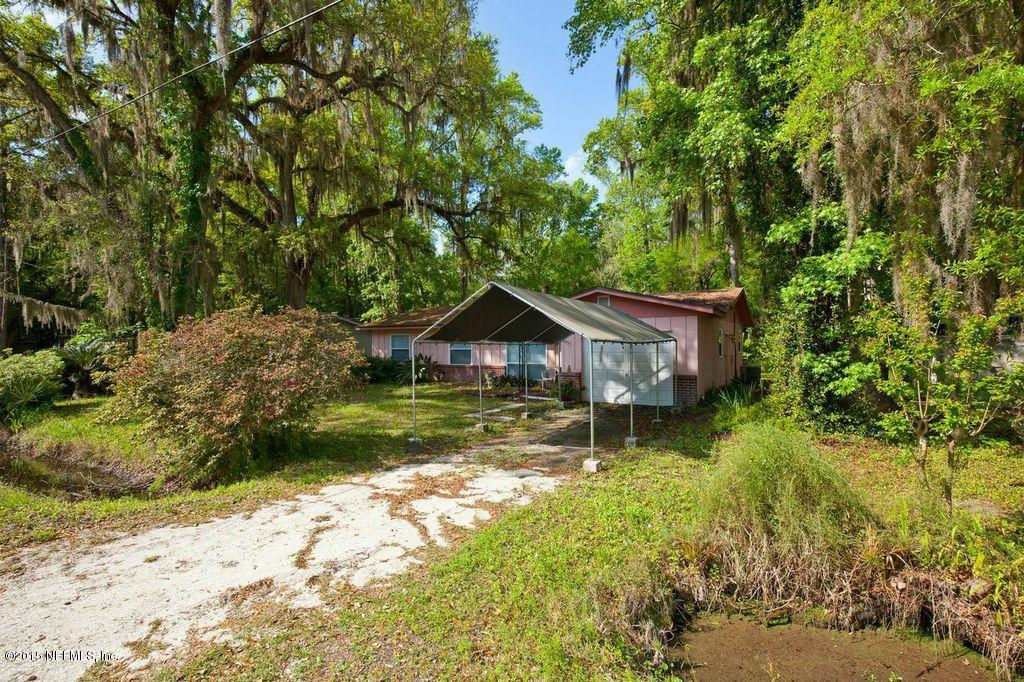 1975 Deer Run Road St. Augustine, FL 32084 - Photo 11 of 35 a backyard of a house with a yard and large tree