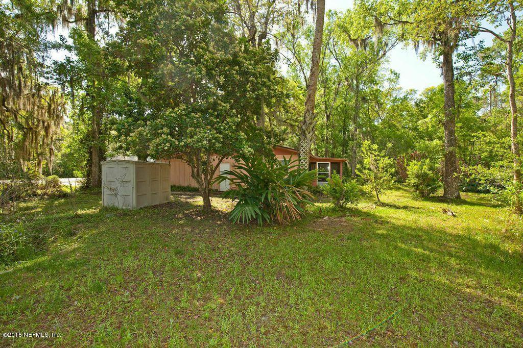 1975 Deer Run Road St. Augustine, FL 32084 - Photo 17 of 35 a backyard of a house with plants and large trees