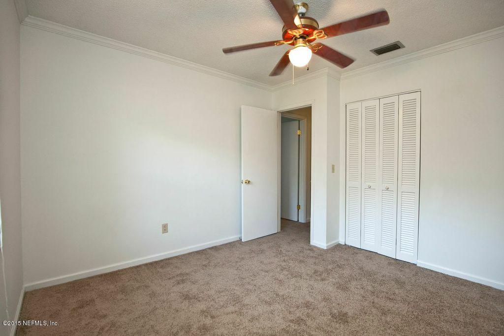 1975 Deer Run Road St. Augustine, FL 32084 - Photo 20 of 35 an empty room with closet and a chandelier fan
