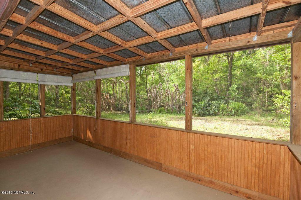 1975 Deer Run Road St. Augustine, FL 32084 - Photo 22 of 35 a view of empty room with large windows and city view