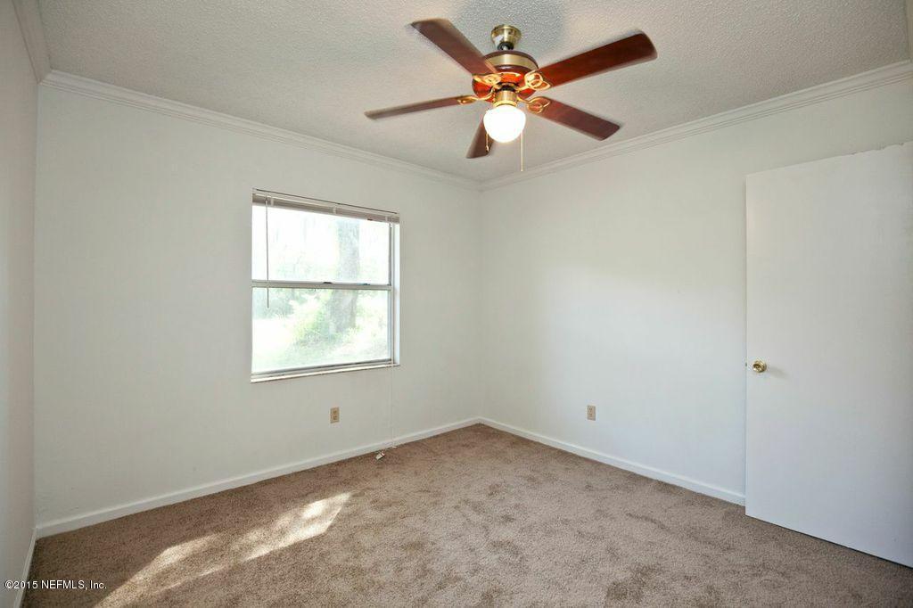 1975 Deer Run Road St. Augustine, FL 32084 - Photo 23 of 35 an empty room with a window and a fan