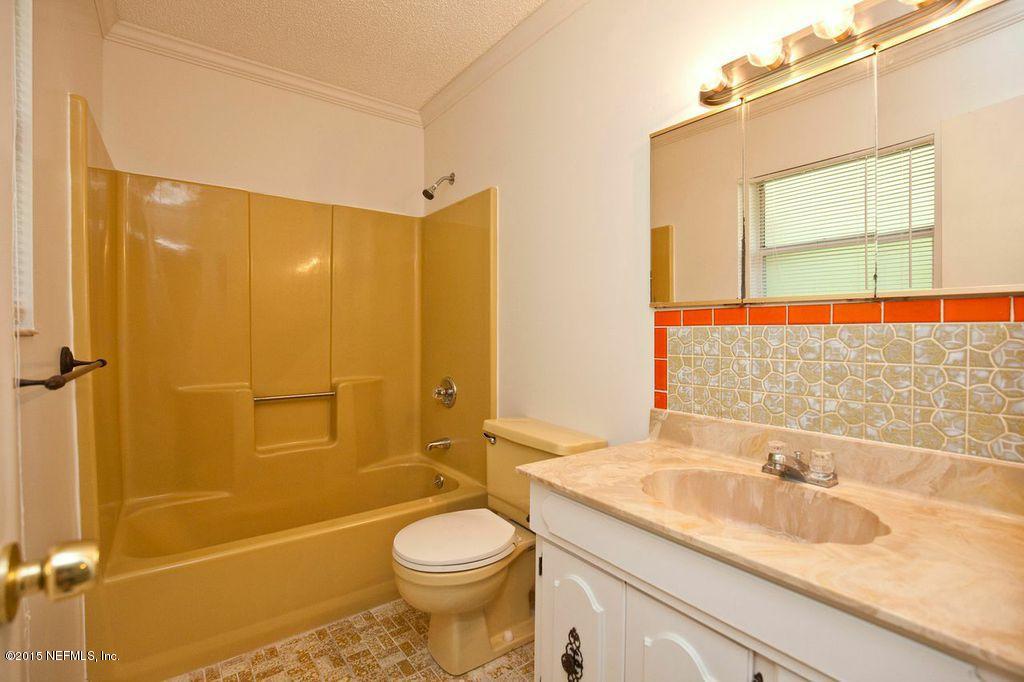 1975 Deer Run Road St. Augustine, FL 32084 - Photo 25 of 35 a bathroom with a sink a toilet and shower