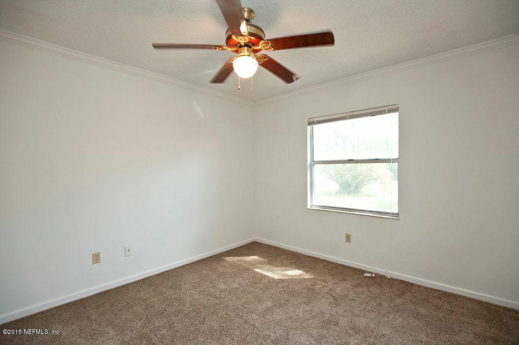 1975 Deer Run Road St. Augustine, FL 32084 - Photo 30 of 35 an empty room with a window and a fan