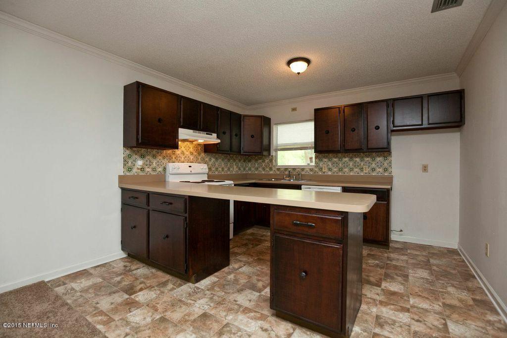 1975 Deer Run Road St. Augustine, FL 32084 - Photo 3 of 35 a kitchen with a sink cabinets and wooden floor