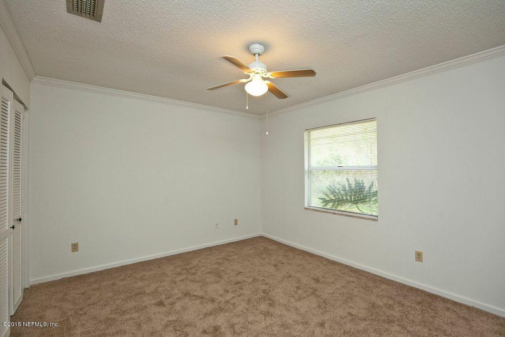 1975 Deer Run Road St. Augustine, FL 32084 - Photo 31 of 35 an empty room with a window and a fan