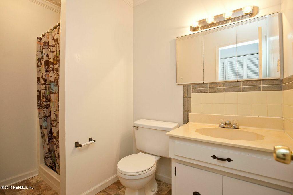 1975 Deer Run Road St. Augustine, FL 32084 - Photo 32 of 35 a bathroom with a sink a toilet and a mirror