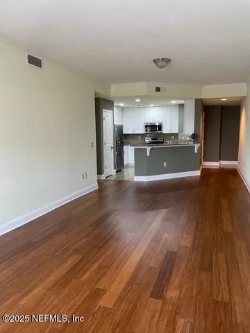 a kitchen with granite countertop a refrigerator stove and microwave