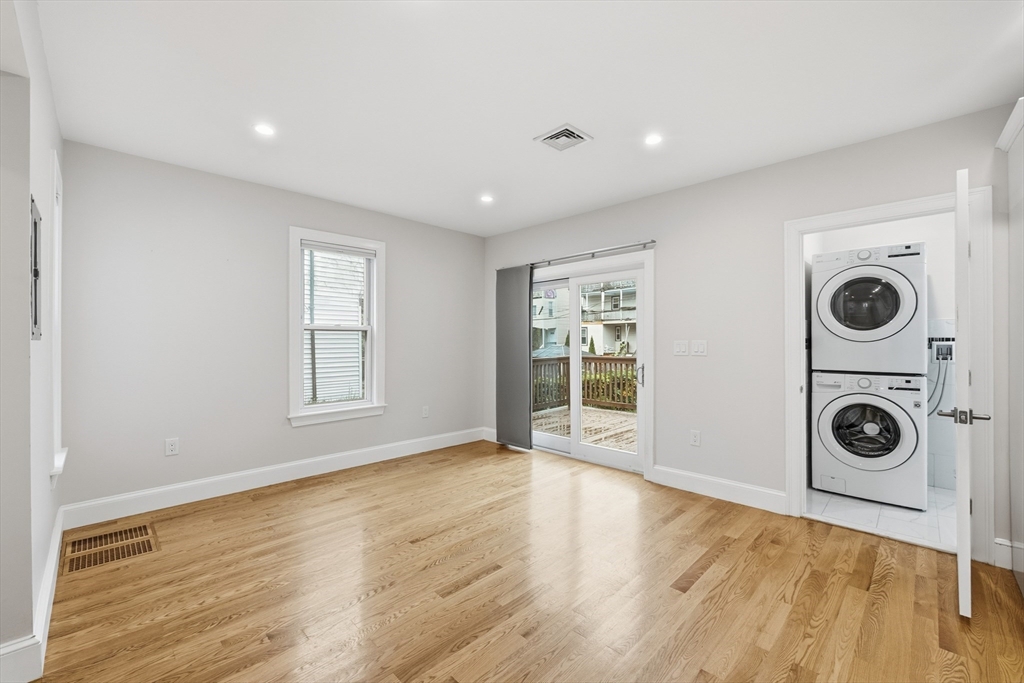 31 Chipman Street Boston, MA 02124 - Photo 12 of 37 a view of empty room with wooden floor and fan