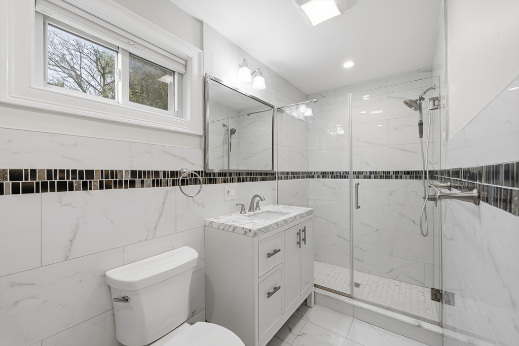 31 Chipman Street Boston, MA 02124 - Photo 13 of 37 a bathroom with a toilet sink and mirror