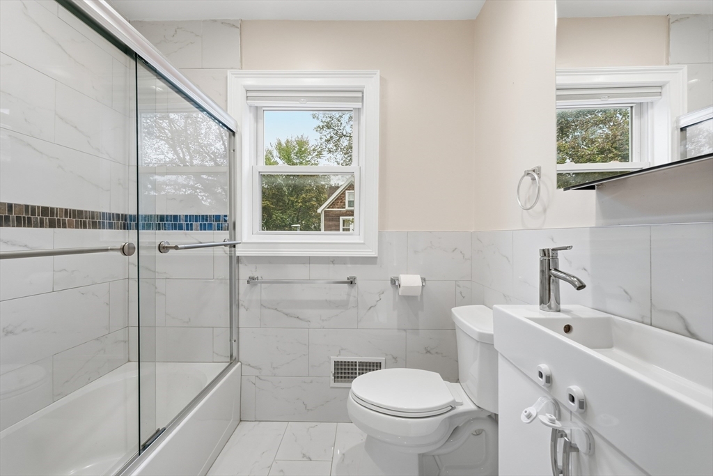 31 Chipman Street Boston, MA 02124 - Photo 15 of 37 a bathroom with a sink toilet and shower