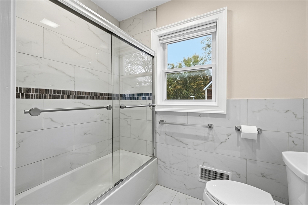 31 Chipman Street Boston, MA 02124 - Photo 16 of 37 a bathroom with a toilet and a shower