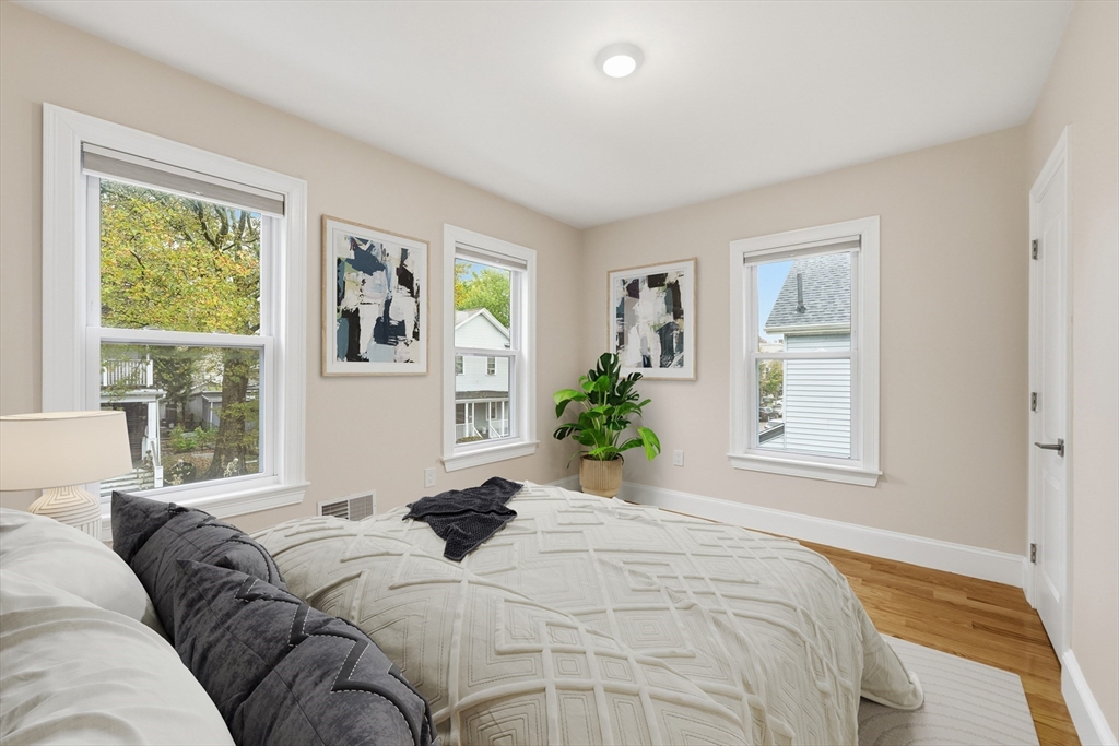 31 Chipman Street Boston, MA 02124 - Photo 18 of 37 a bedroom with a large bed and a window