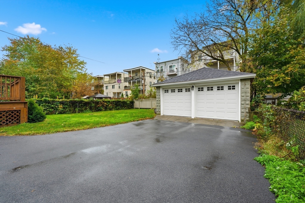 31 Chipman Street Boston, MA 02124 - Photo 30 of 37 a front view of a house with a yard and garage