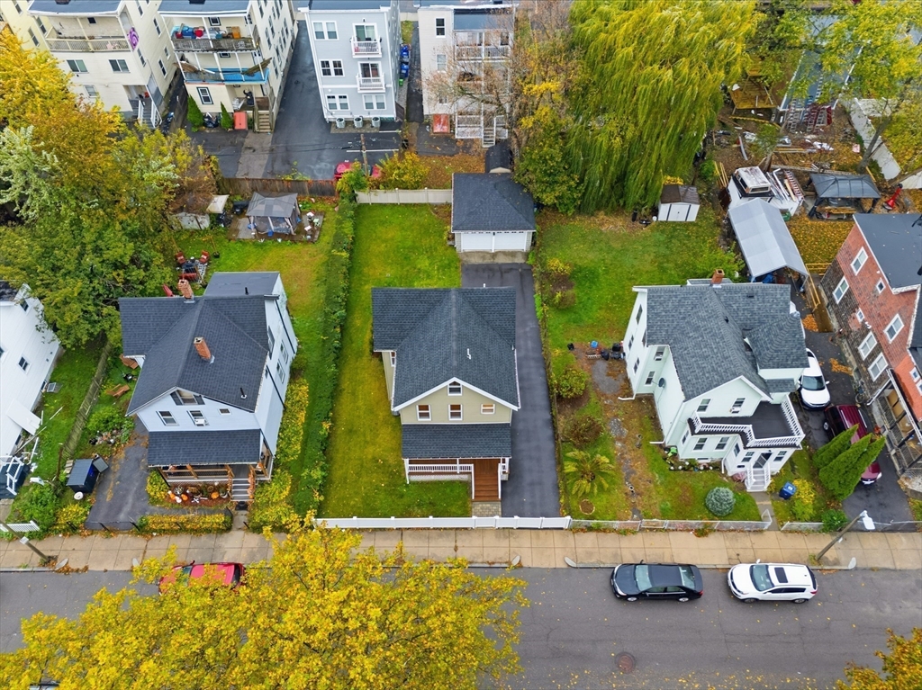 31 Chipman Street Boston, MA 02124 - Photo 33 of 37 an aerial view of residential houses with outdoor space and parking