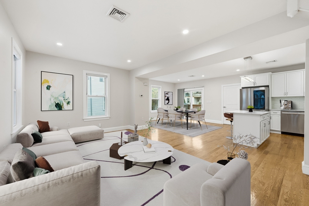 31 Chipman Street Boston, MA 02124 - Photo 4 of 37 a living room with furniture and wooden floor