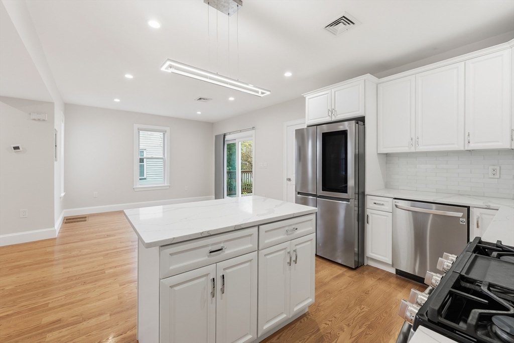 31 Chipman Street Boston, MA 02124 - Photo 8 of 37 a kitchen with a refrigerator and a stove top oven