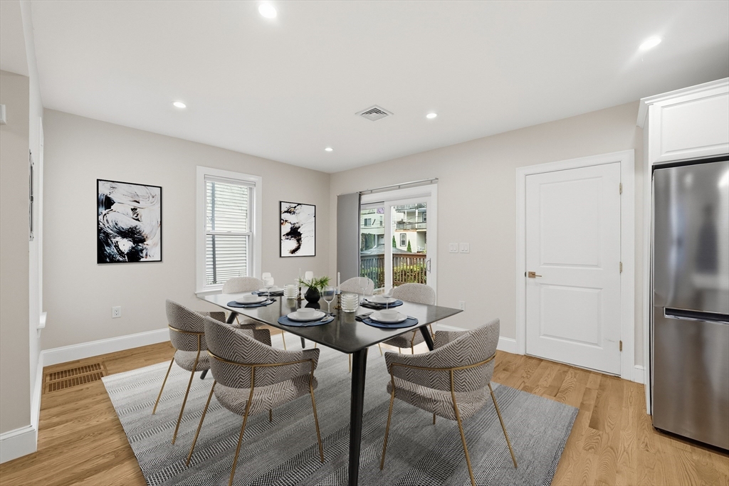 31 Chipman Street Boston, MA 02124 - Photo 9 of 37 a dining room with furniture and a refrigerator
